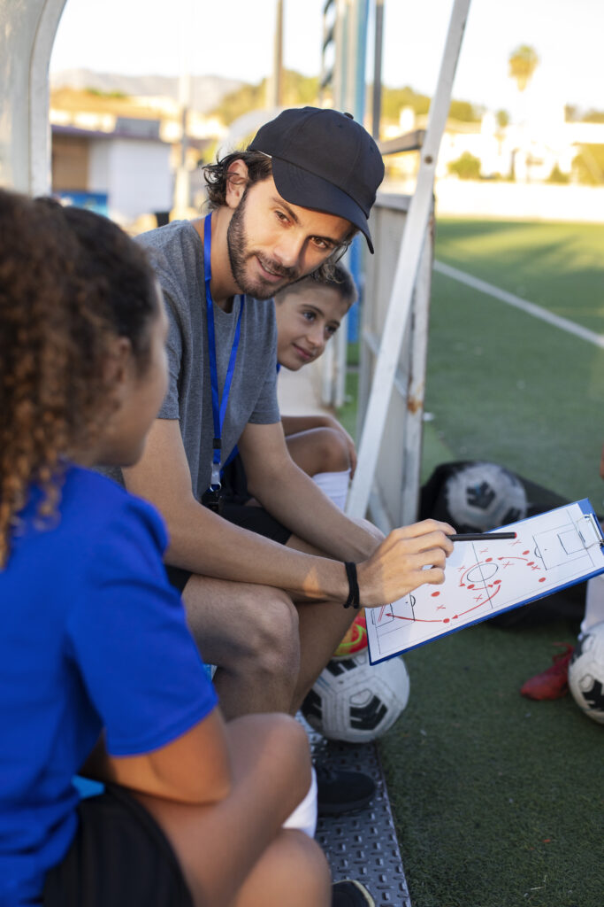 oil-1 side view football trainer teaching kids